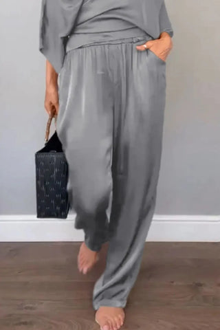 Model styling black wrap jumpsuit with short wide sleeves – Voguelle
