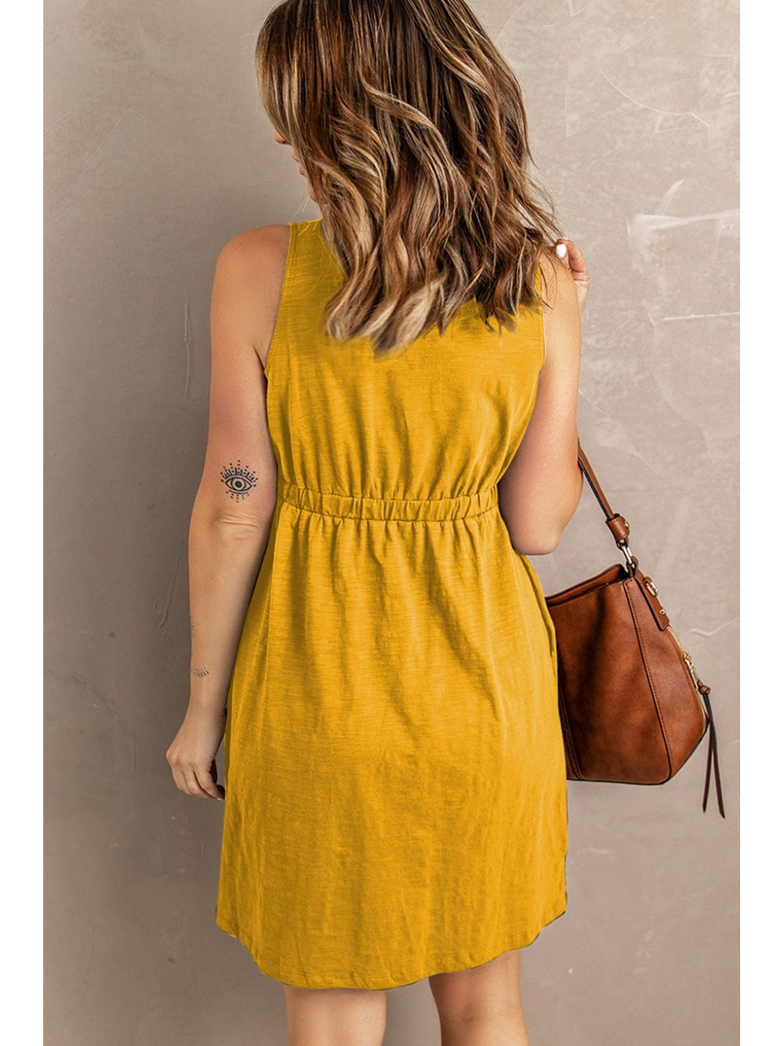 Walking view of black button down sleeveless mini dress – Voguelle