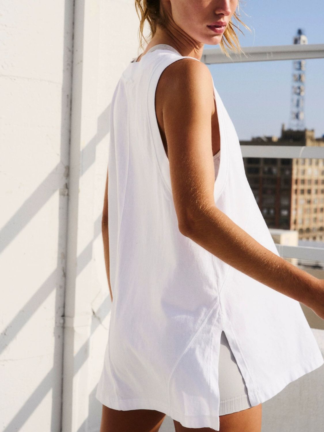 Front view of side slit V-neck tank top in white – Voguelle